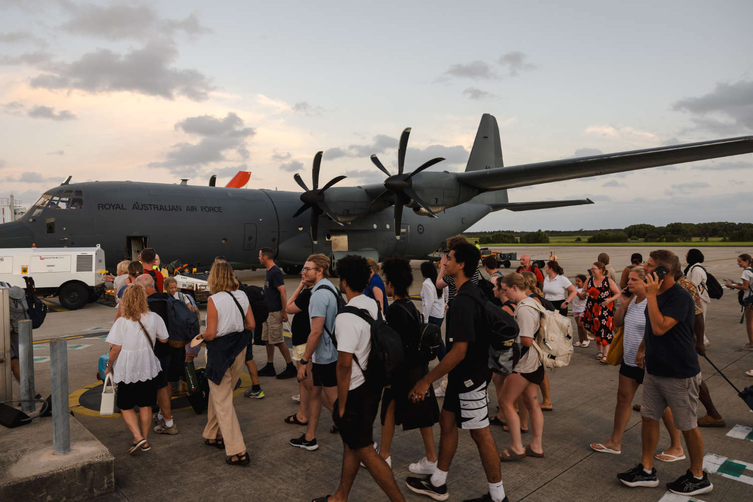 Australians are assisted off a C-130J Hercules at Brisbane Airport following the earthquake which struck Port Vila, Vanuatu.